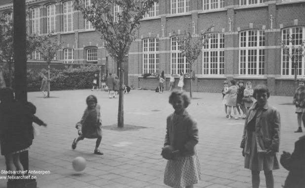 Speelkoer meisjesschool Onderwijzersstraat, op de achtergrond het schoolgebouw, 1950-1960